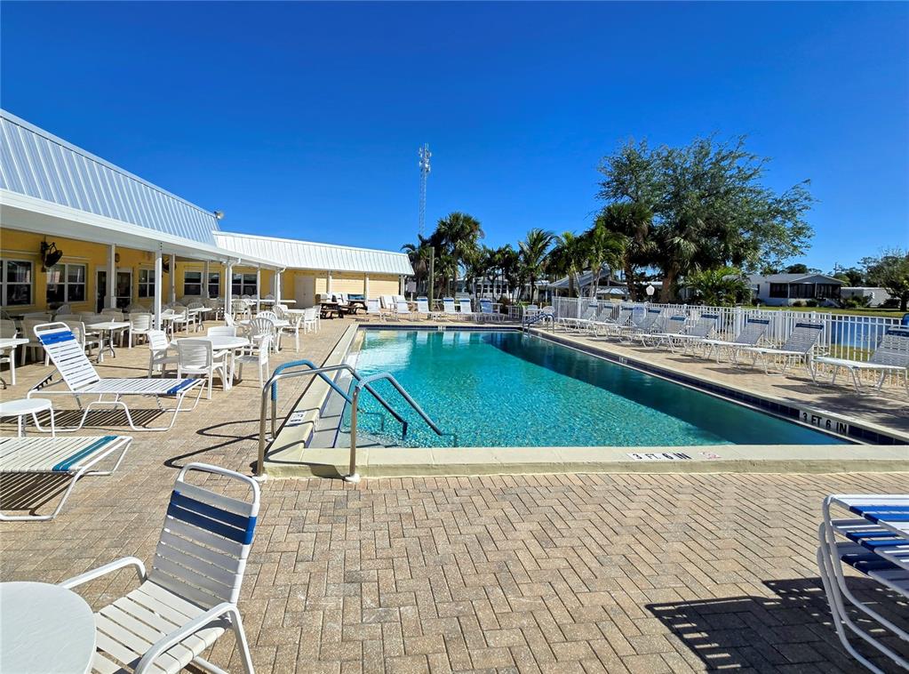 10303 Burnt Store Road, Unit 93 Punta Gorda, FL 33950 - Photo 62 of 65 a view of a swimming pool with a lounge chair