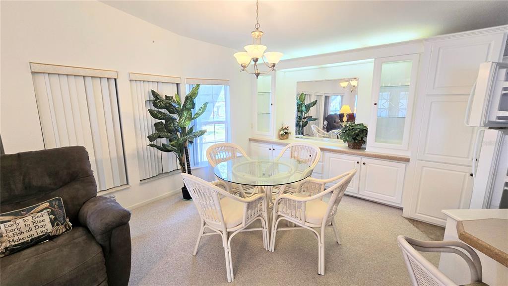 10303 Burnt Store Road, Unit 93 Punta Gorda, FL 33950 - Photo 8 of 65 a dining room with furniture and window