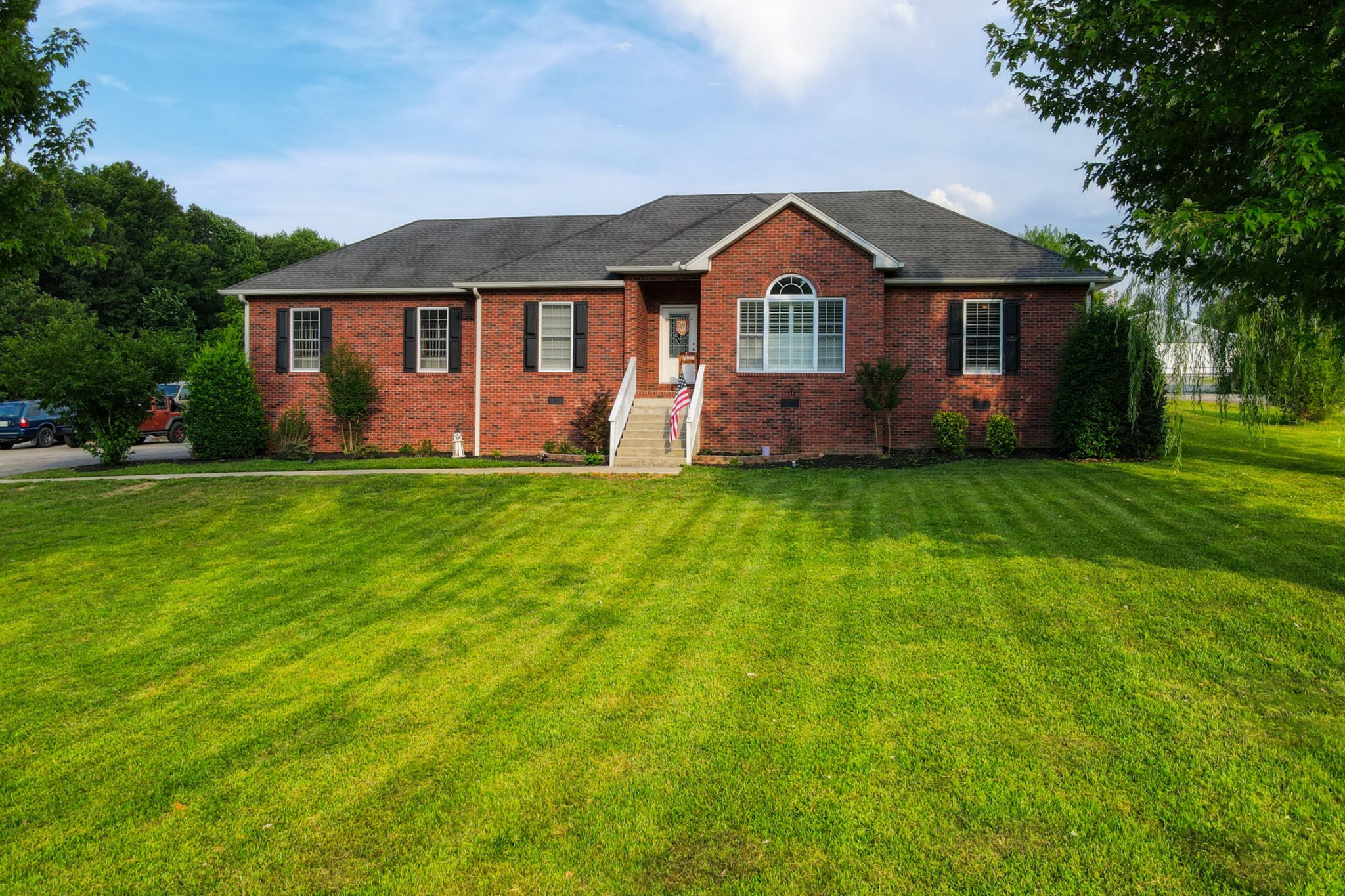a front view of a house with a garden