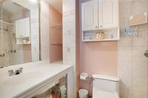 a bathroom with a sink toilet and shower