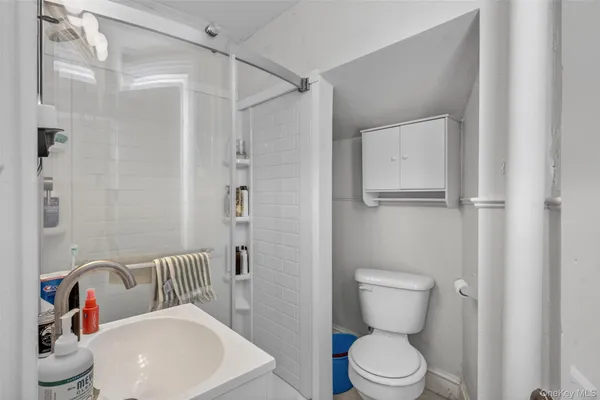 a bathroom with a toilet a sink and shower