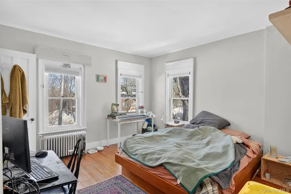 a bedroom with furniture and a window