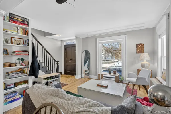 a living room with furniture and a book shelf