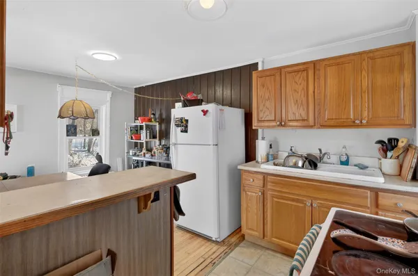 a kitchen with a refrigerator and a stove top oven