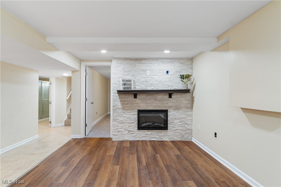 791 Center Road New Franklin, OH 44319 - Photo 22 of 35 Lower level living room in additional living suite with fireplace