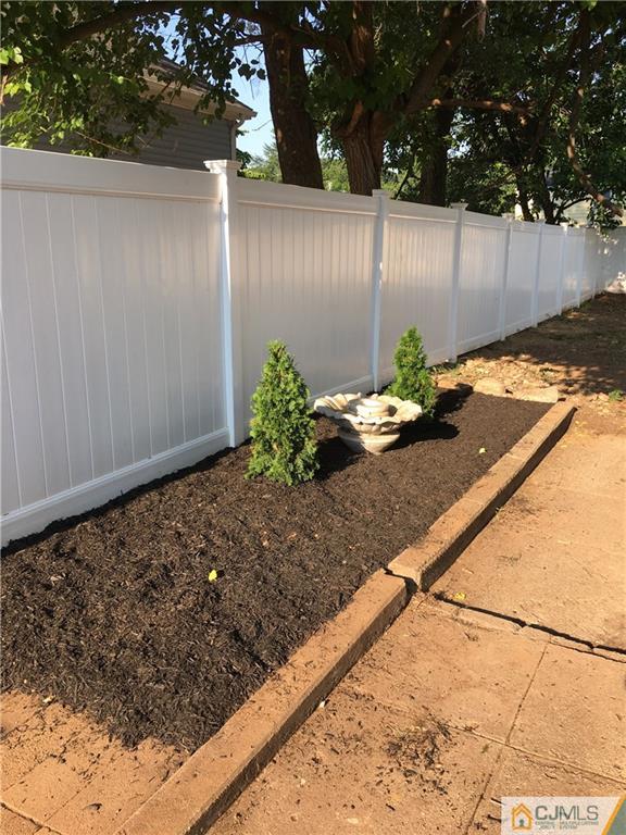 88 Winthrop Road Edison, NJ 08817 - Photo 14 of 15 a view of a backyard with plants and wooden fence