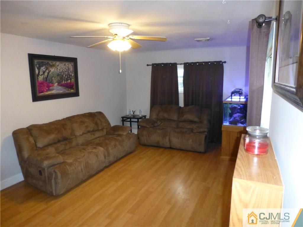 88 Winthrop Road Edison, NJ 08817 - Photo 3 of 15 a living room with furniture and a flat screen tv