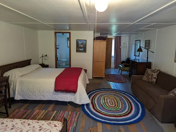 a bedroom with bed and a chandelier