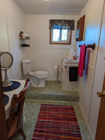 a bathroom with a toilet and a mirror