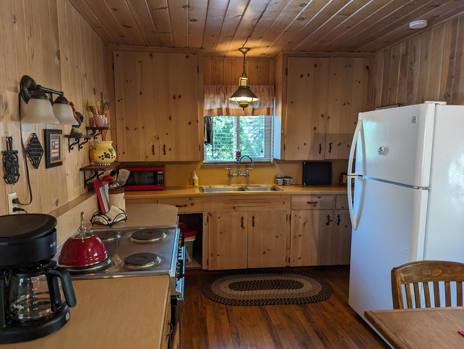 48603 Todd Eymann Road Miramonte, CA 93641 - Photo 6 of 13 a kitchen with a refrigerator and a stove top oven