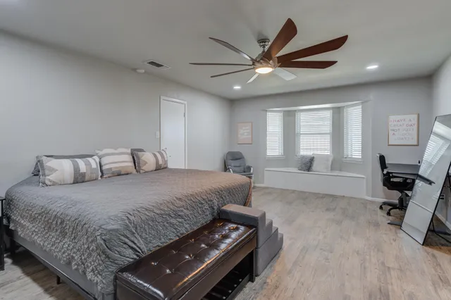 a bedroom with a large bed and a window