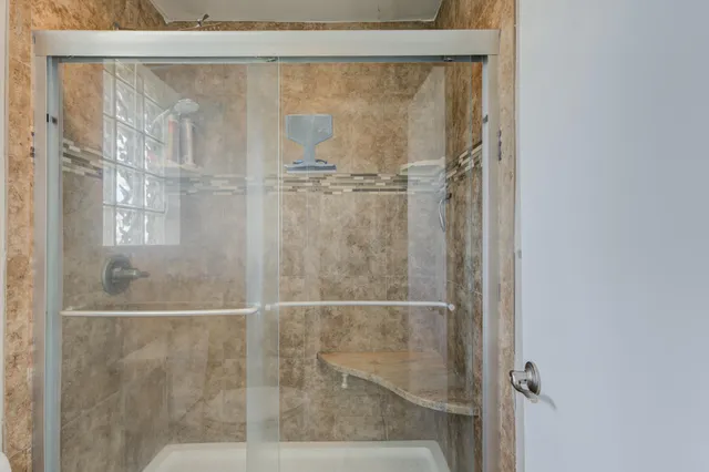 a bathroom with a glass shower door