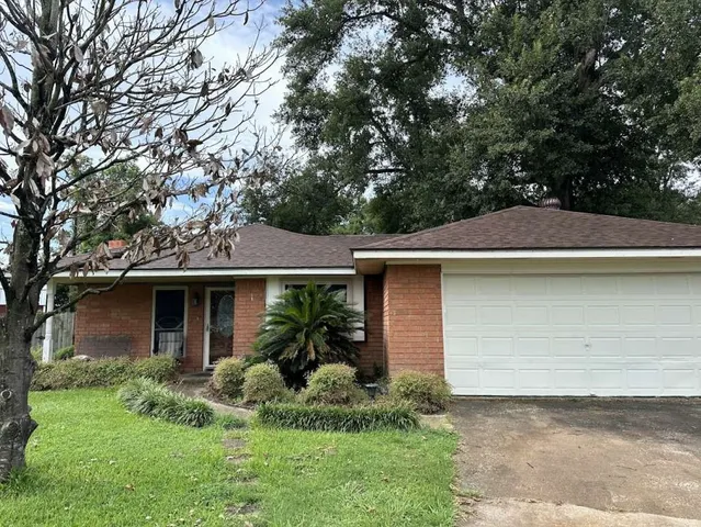 a front view of house with yard and trees