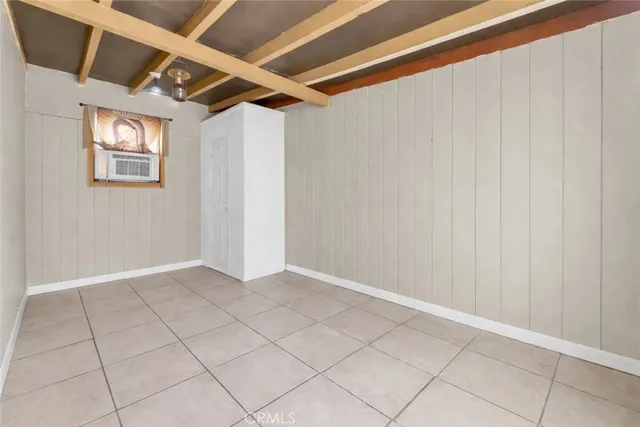 a room with a bed and a flat screen tv