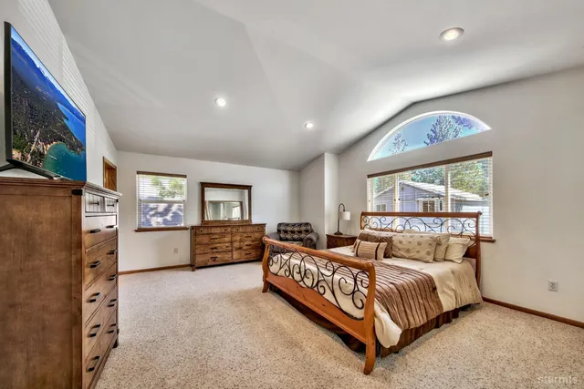 a bedroom with furniture and a flat screen tv