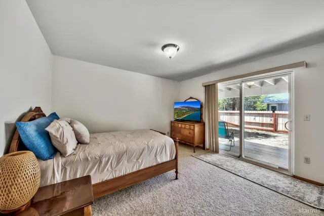 a bed room with a bed and a chair