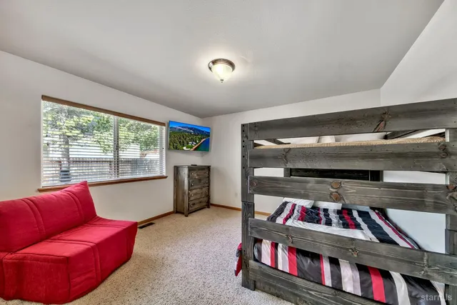 a living room with furniture and a book shelf