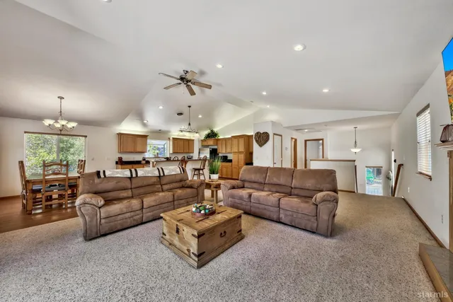 a living room with furniture ceiling fan and a window