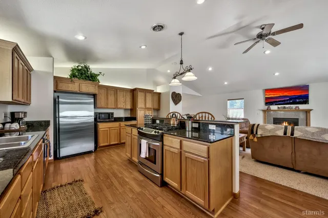 a kitchen with stainless steel appliances granite countertop a stove and refrigerator