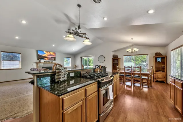 a kitchen with stainless steel appliances granite countertop a stove and refrigerator