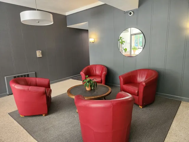 a living room with furniture and a mirror