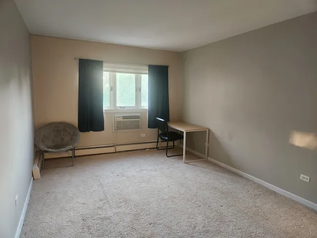 an empty room with furniture and a window