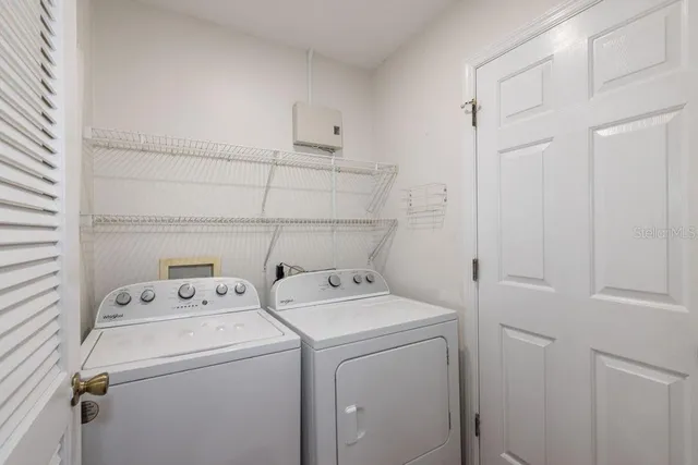 a view of storage and utility room with washer and dryer