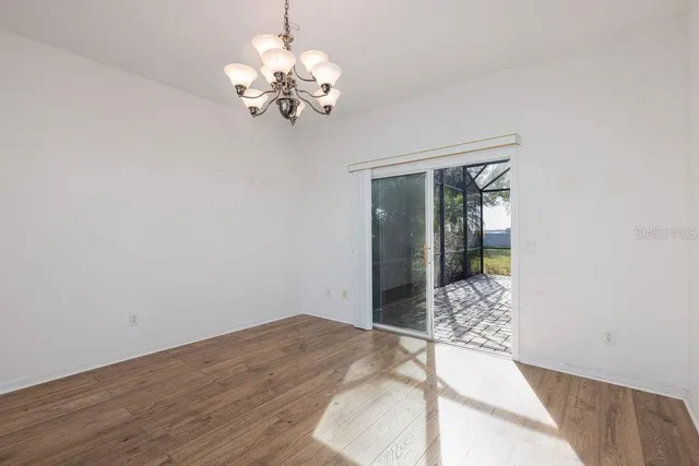 a view of a bedroom with wooden floor