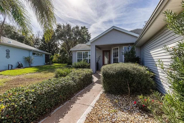 a front view of a house with a garden
