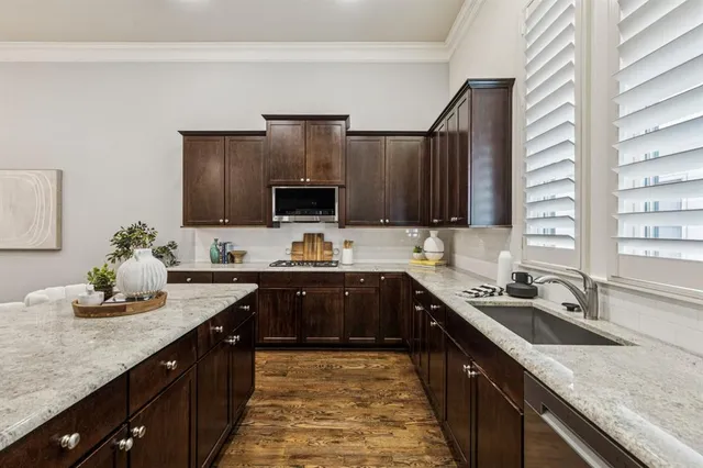 a kitchen with a sink stove top oven and microwave