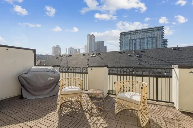 a balcony with a table and chairs