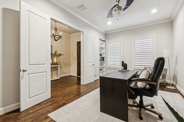 a view of a workspace with furniture and wooden floor
