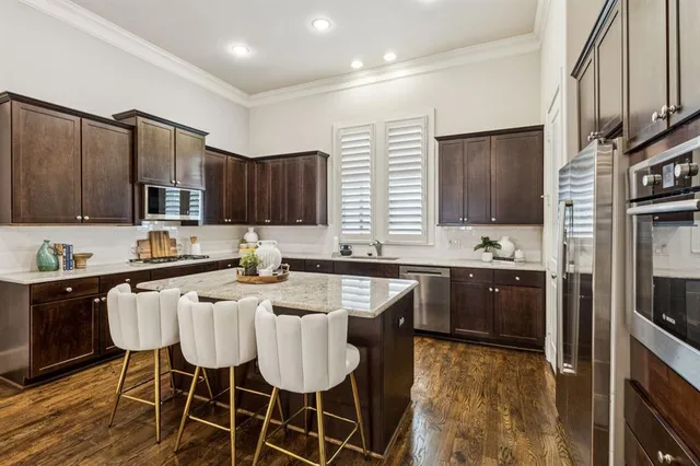 a kitchen with granite countertop a sink stove and refrigerator