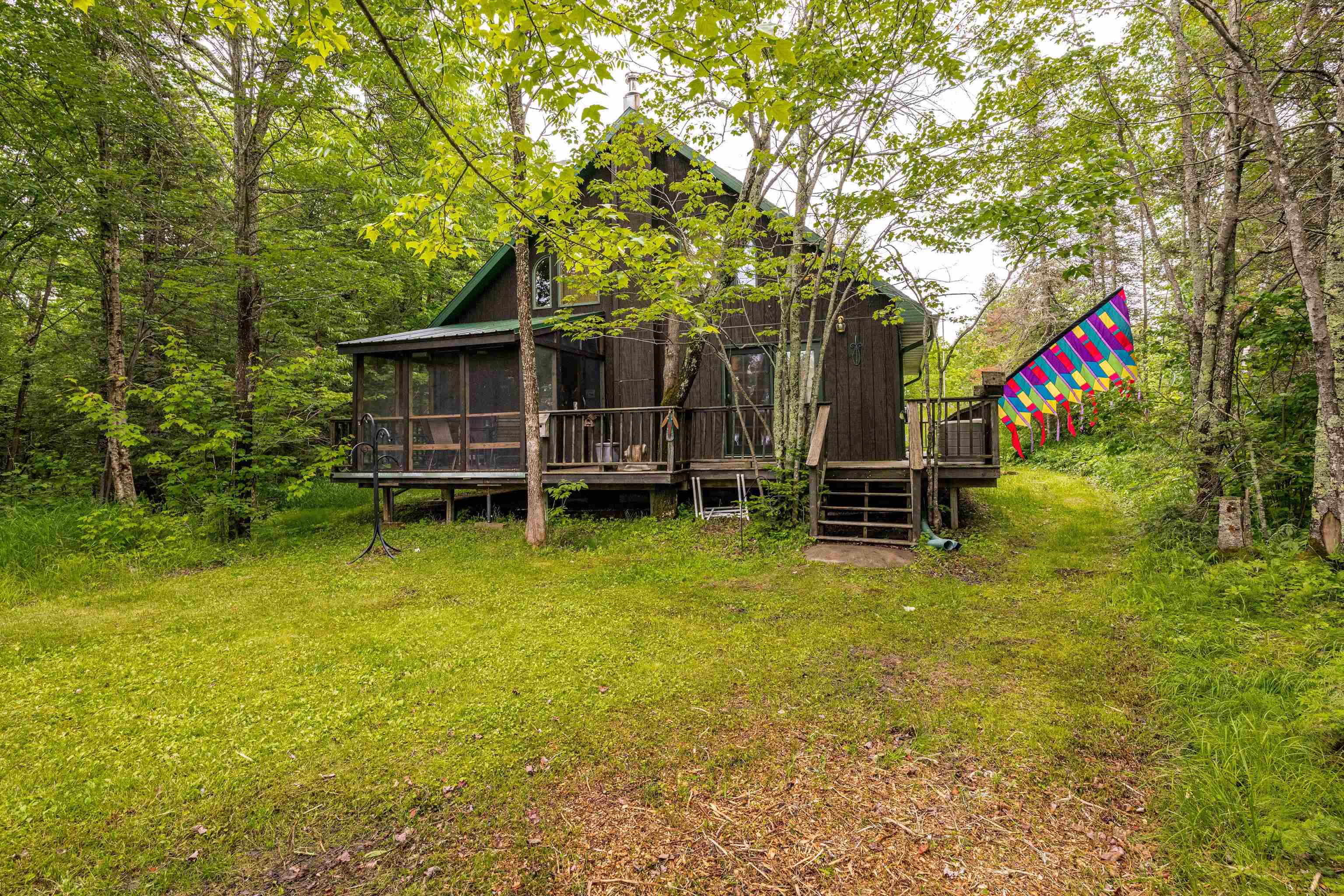 1207 Christianson Lake Road Two Harbors, MN 55616 - Photo 2 of 36 Back of property featuring a sunroom, a deck, and stairs