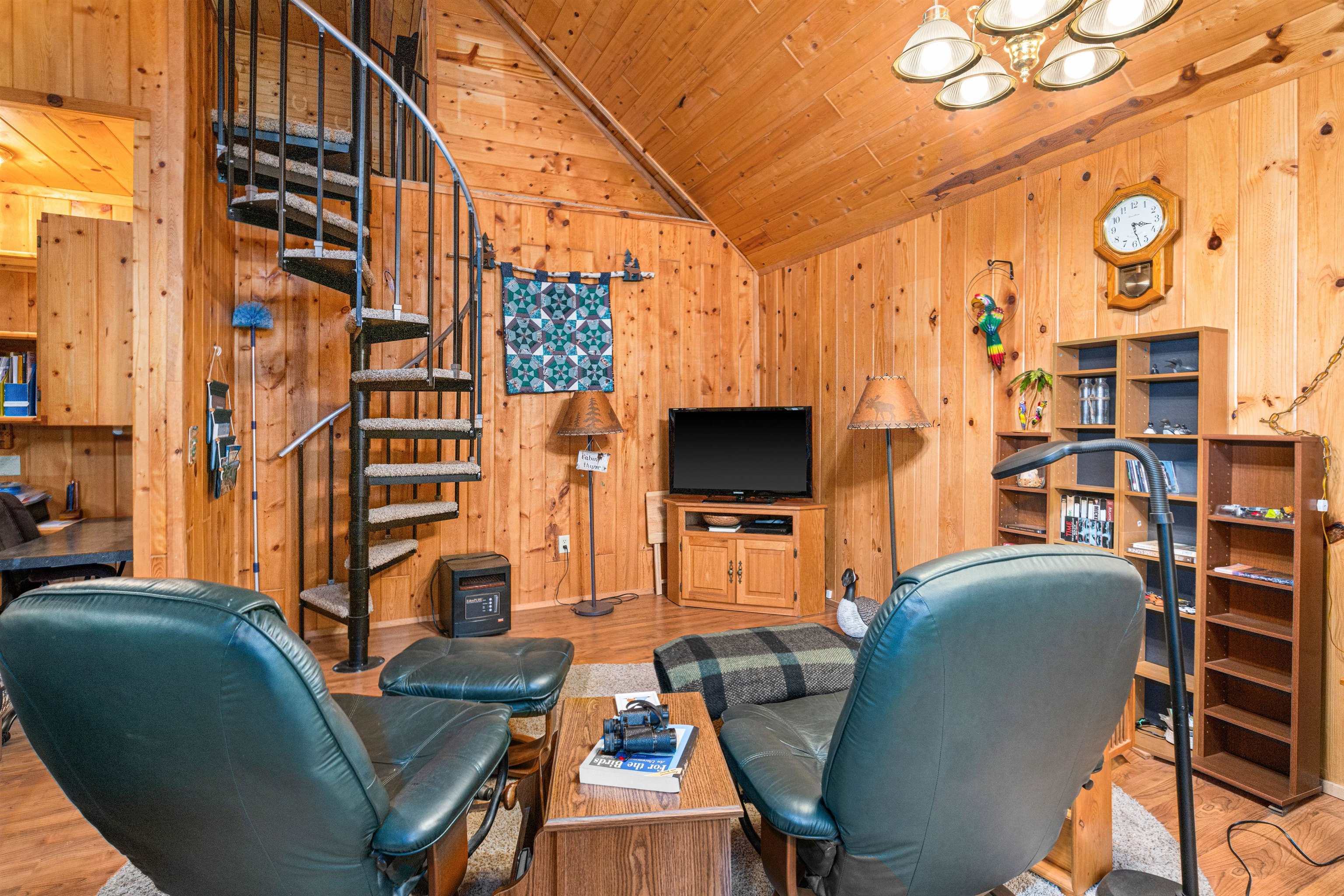 1207 Christianson Lake Road Two Harbors, MN 55616 - Photo 9 of 36 Living room with wooden walls, wooden ceiling, wood finished floors, a chandelier, and vaulted ceiling