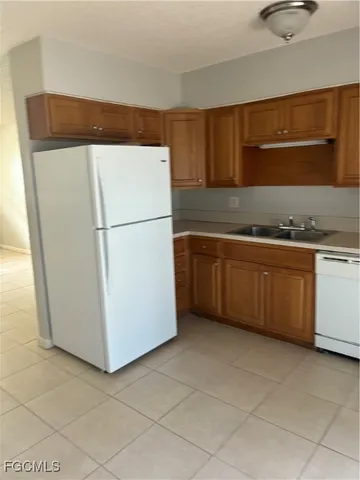 a utility room with sink dryer and washer