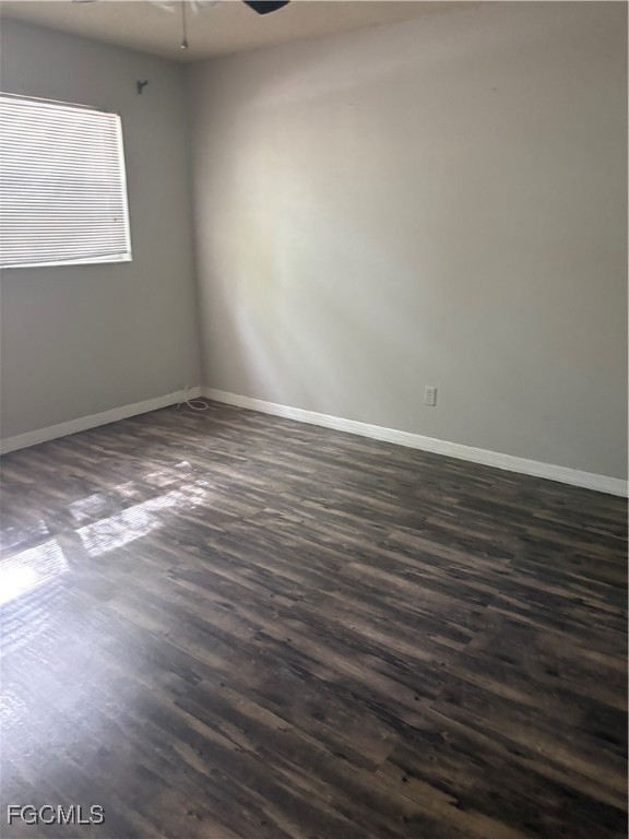 1560 Colonial Boulevard, Unit 136 Fort Myers, FL 33907 - Photo 9 of 10 a view of an empty room with wooden floor and a window