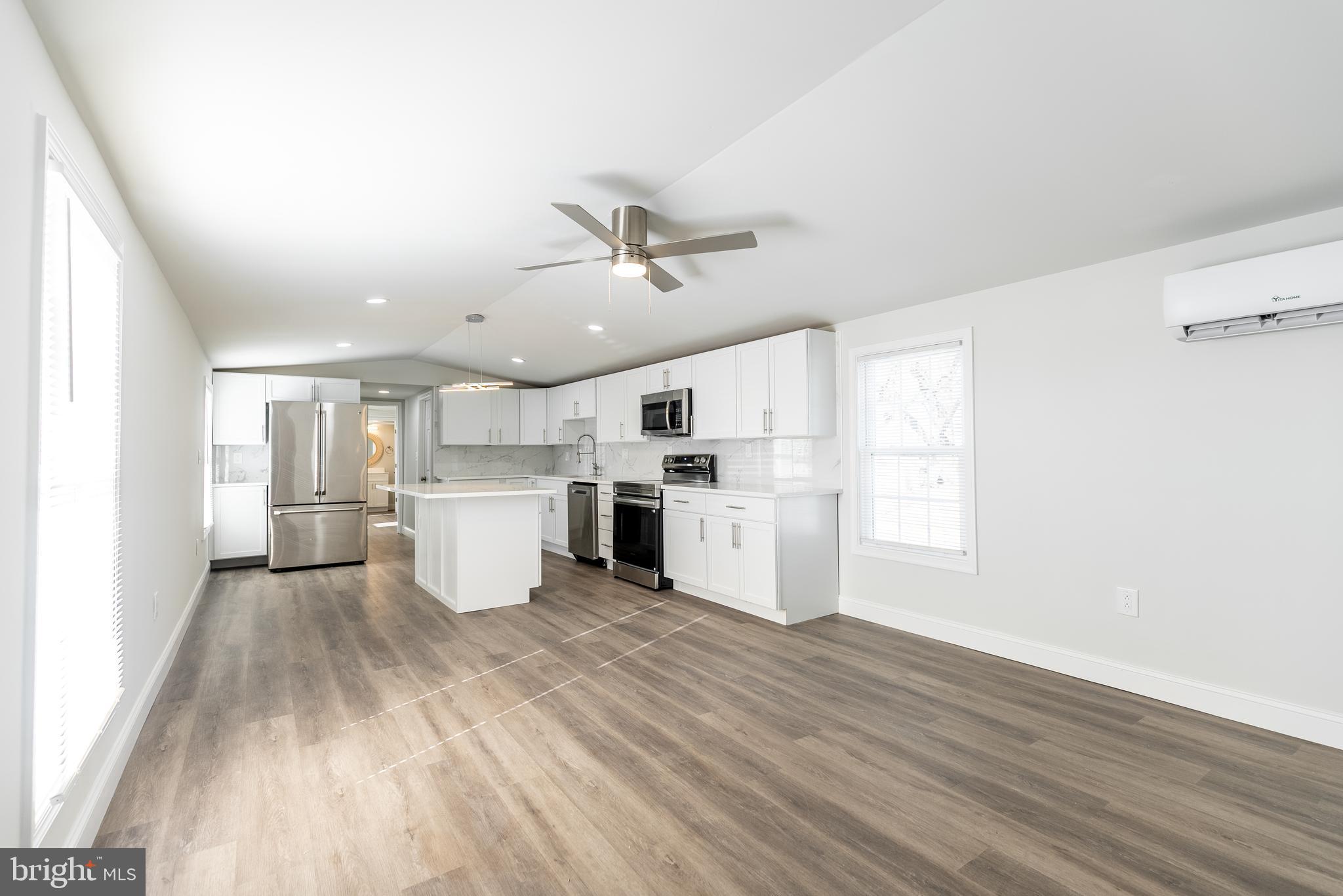 a view of a kitchen with wooden floor