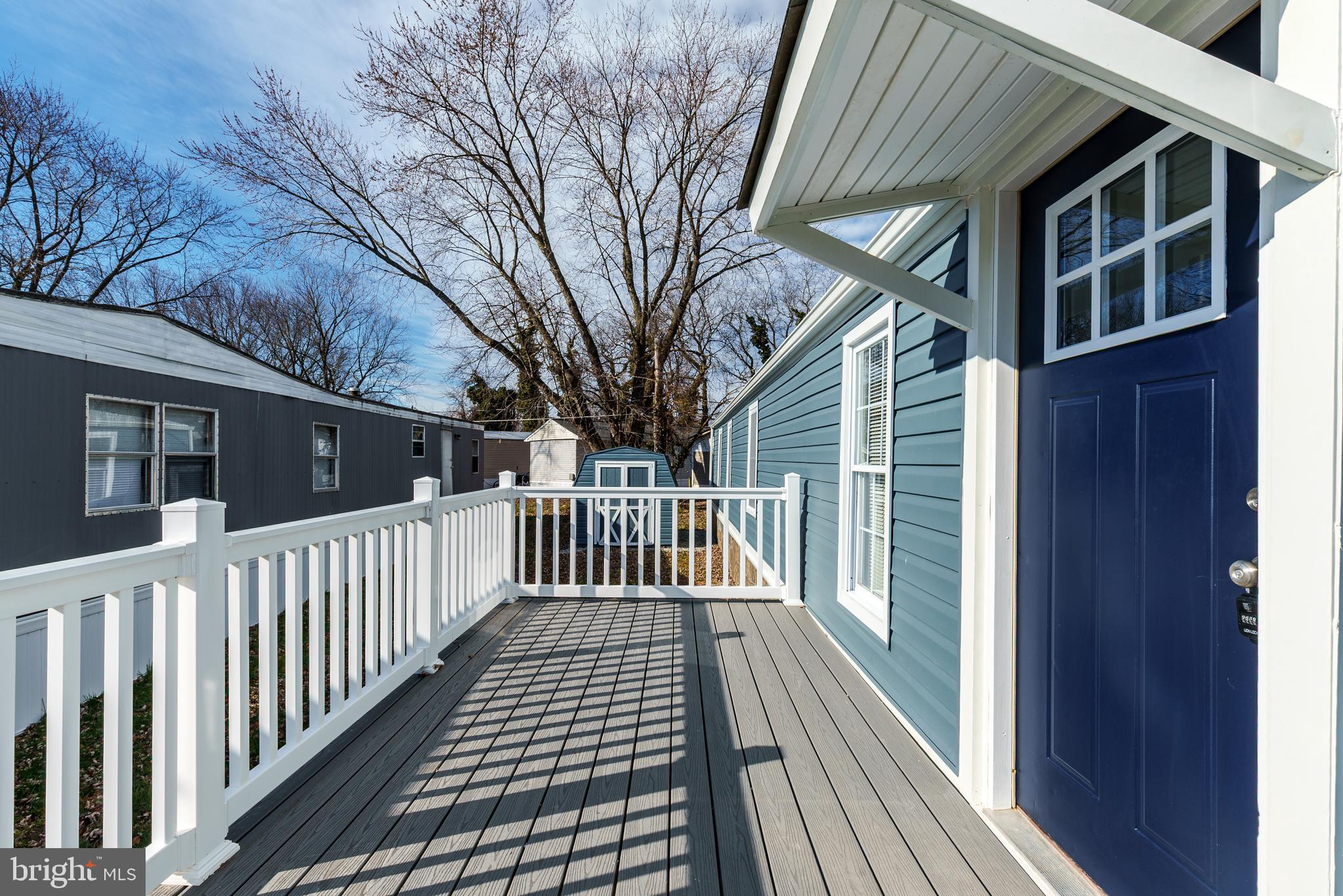 115 5th Street, Unit 40 Delaware City, DE 19706 - Photo 11 of 12 a view of a wooden house with a large window