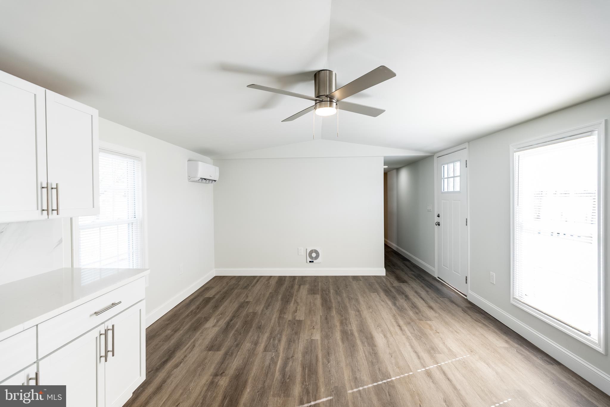115 5th Street, Unit 40 Delaware City, DE 19706 - Photo 3 of 12 a view of empty room with wooden floor and fan
