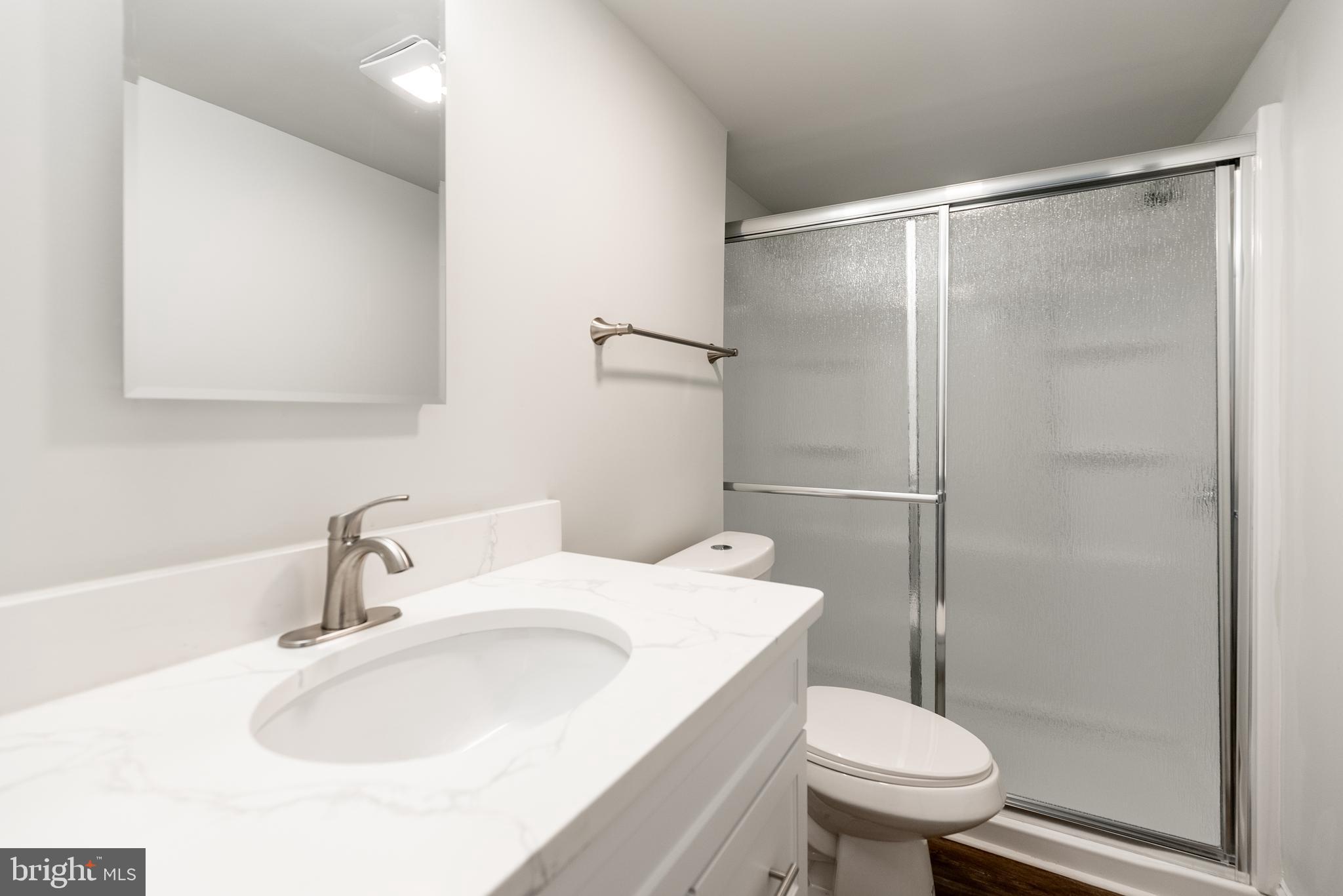 115 5th Street, Unit 40 Delaware City, DE 19706 - Photo 9 of 12 a bathroom with a sink toilet and shower