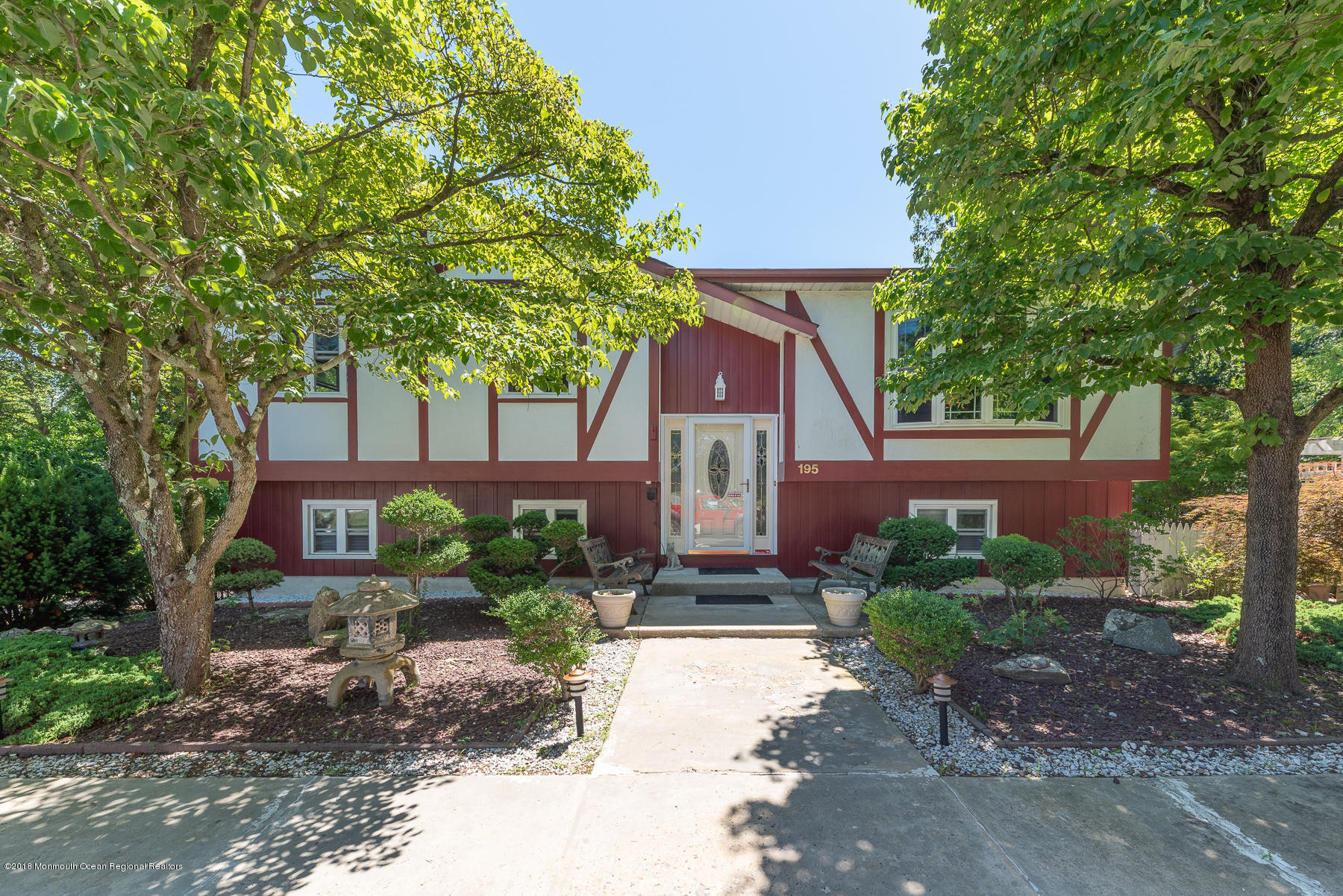 a front view of a house with garden