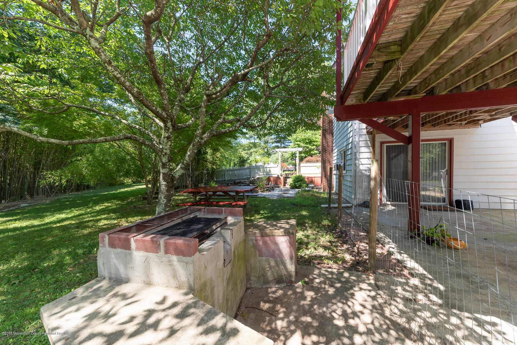 195 South New Prospect Road Jackson, NJ 08527 - Photo 24 of 28 a view of a backyard with table and chairs with wooden fence and plants