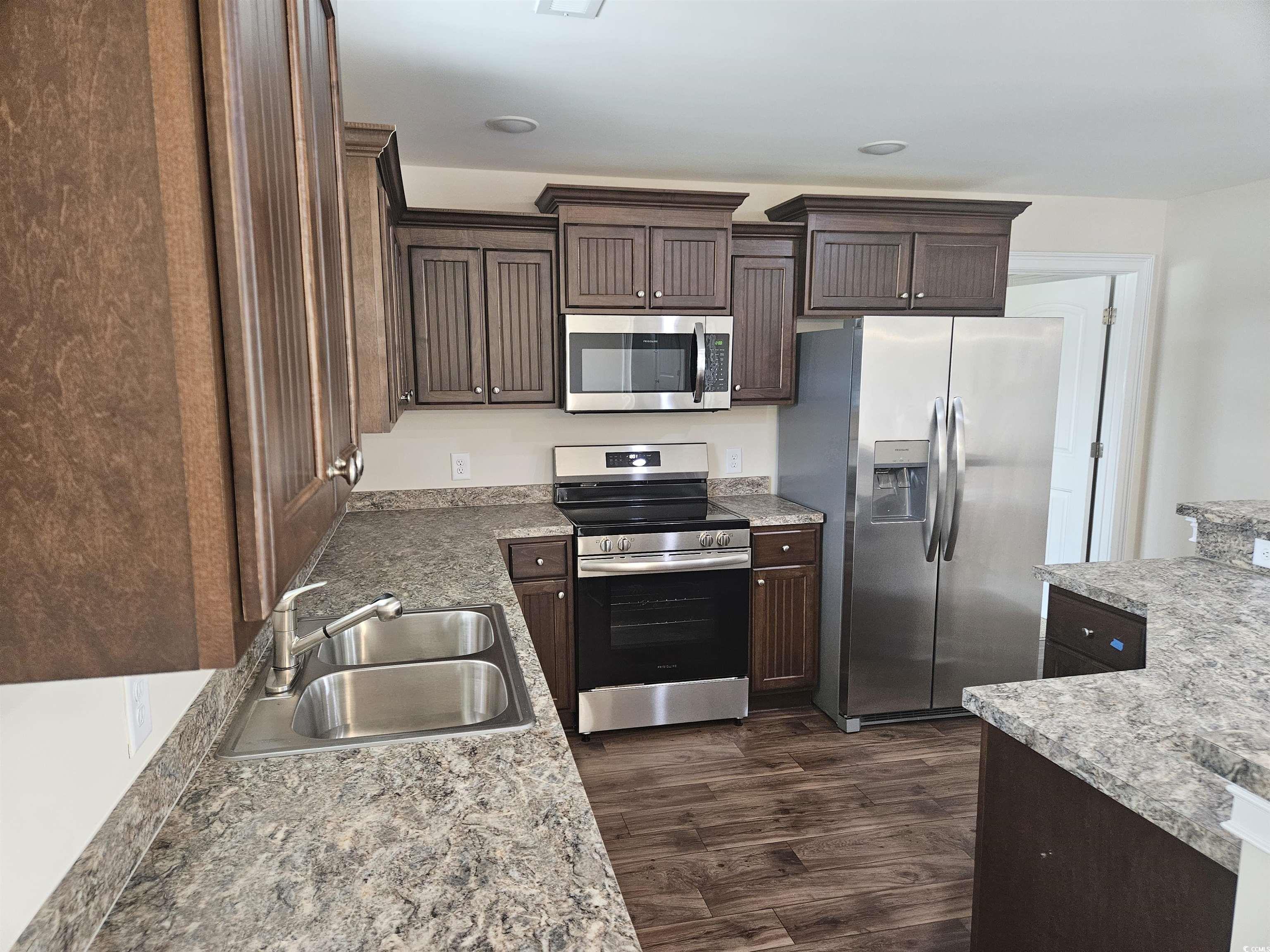416 Hallie Martin Road Conway, SC 29527 - Photo 5 of 24 Kitchen featuring dark brown cabinetry, sink, appl