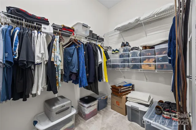 a view of an empty room with a ceiling fan