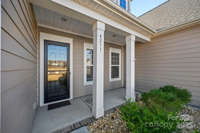 an empty room with wooden floor and bathroom
