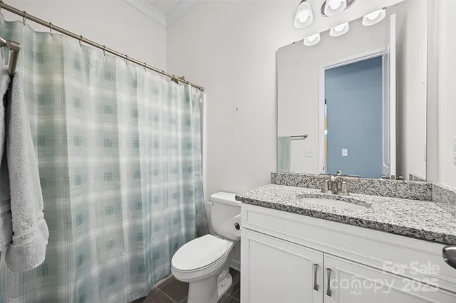 a kitchen with a sink a stove a refrigerator and white cabinets