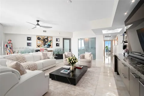 a living room with furniture flat screen tv and a fireplace
