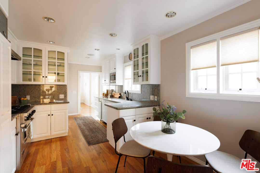 1640 Ard Eevin Avenue Glendale, CA 91202 - Photo 13 of 32 a kitchen with stainless steel appliances a dining table and chairs