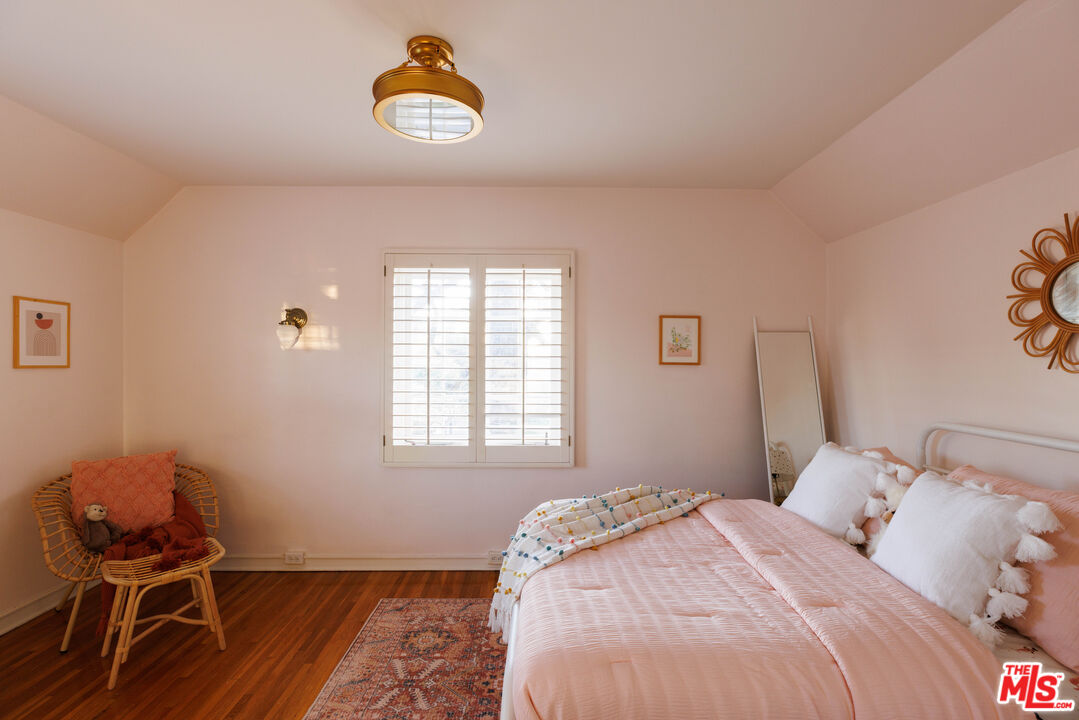 1640 Ard Eevin Avenue Glendale, CA 91202 - Photo 21 of 32 a bedroom with a bed and a chair